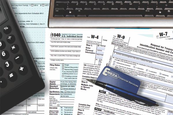   Calculator, pen and keyboard on tax forms.
